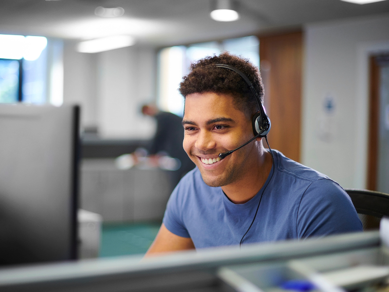 An IT support man talking through a headset